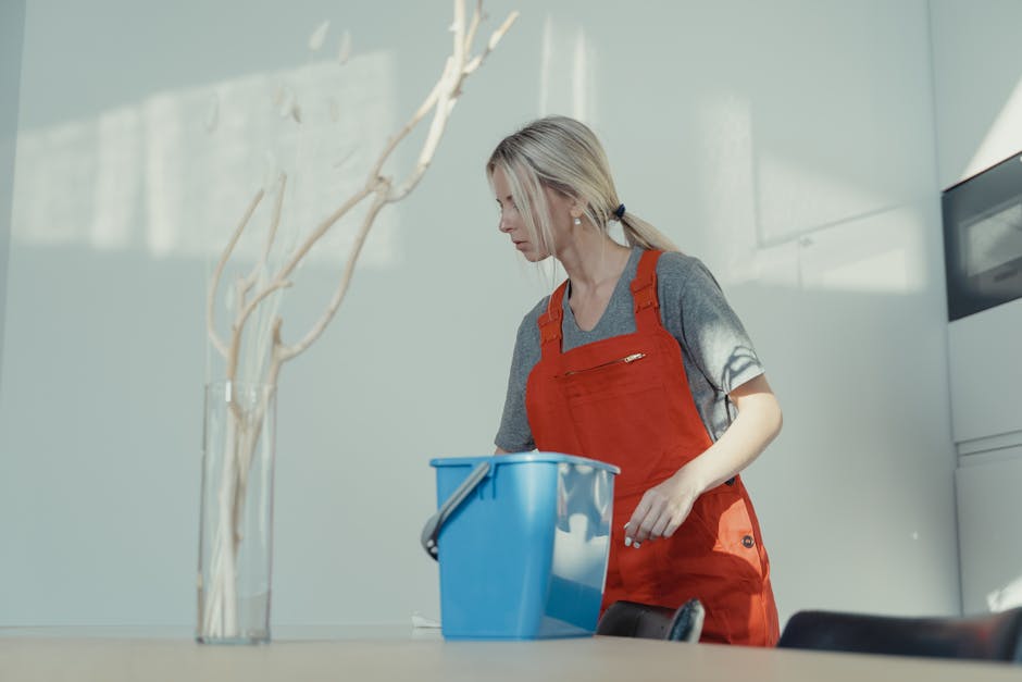 Smiling professional house cleaner ready for service