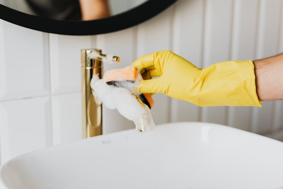Detail cleaning of a modern bathroom sink